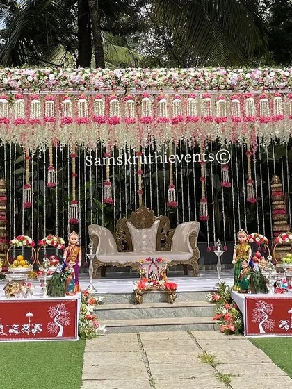 Creating lifetime memories with this grand outdoor setup. The intricate floral canopy and the traditional Warli art on the table covers blend perfectly to create a unique and elegant look.