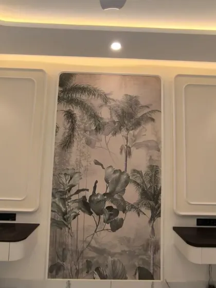 A grayscale jungle mural installed as a central panel between two white cabinets, creating a modern and stylish look.