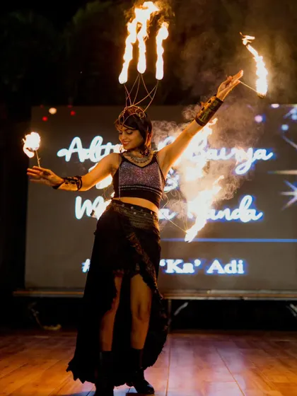 The same pose from a different angle, highlighting the fire crown and palm torches. Every performance is a story told through fire.