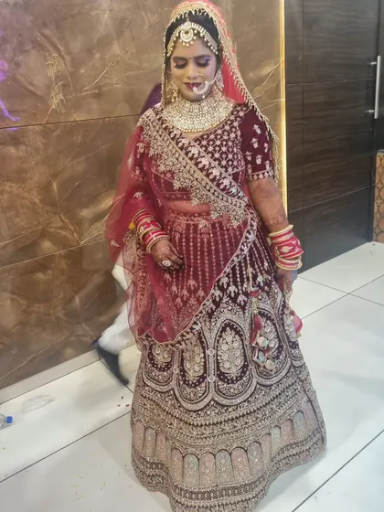 A full-length shot of a bride in her beautiful red lehenga.
