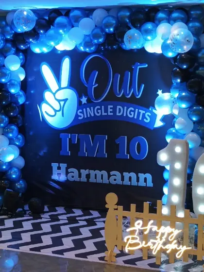 A closer look at the lit-up '10' and the custom backdrop for this stylish 10th birthday party.