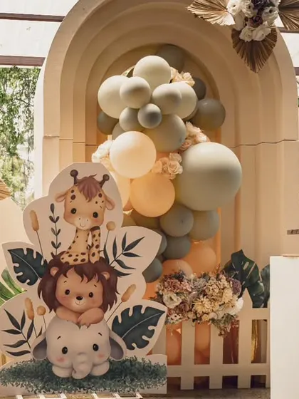 A different take on the "Wild ONE" theme, using cute, cartoonish animal cutouts and earthy-toned balloons. This version is playful and perfect for a first birthday.