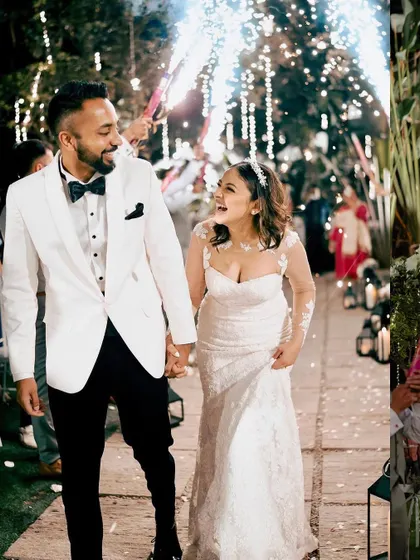 The couple's grand entrance at their reception, surrounded by friends and family holding sparklers. The path is lined with lanterns, creating a truly magical and celebratory moment.