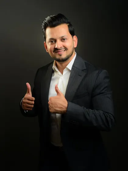 A positive and energetic portrait with a double thumbs-up. This kind of shot is great for internal communications or a social media profile to convey enthusiasm.