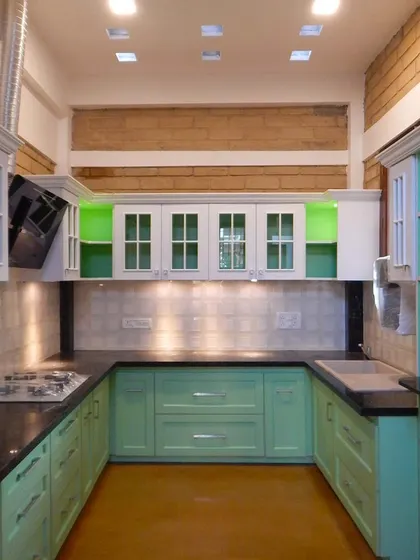 A mint green kitchen under construction, showing the harmony of color and material even before completion.