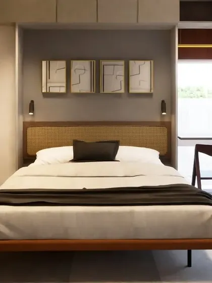 This concept for a 1BHK apartment explores the use of flexible furniture, like a folding bed, to augment the space. A sliding panel with a tropical mural conceals the bed when not in use, transforming the room from a bedroom into a spacious living area.