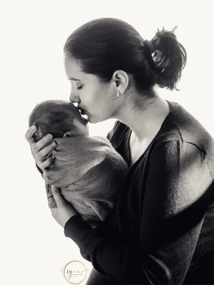 A timeless black and white portrait of a mother's love. This intimate moment is a powerful and emotional keepsake.