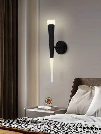 The torch sconce used as a bedside light, providing a soft and relaxing glow.