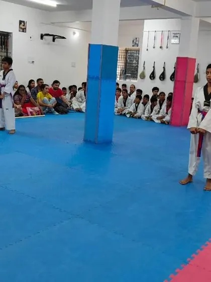 Two students stand ready to perform their synchronized form.