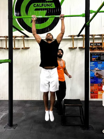 A climber demonstrates his upper body strength during our pull-up competition. These fitness challenges are a great way to supplement climbing training and have some fun.