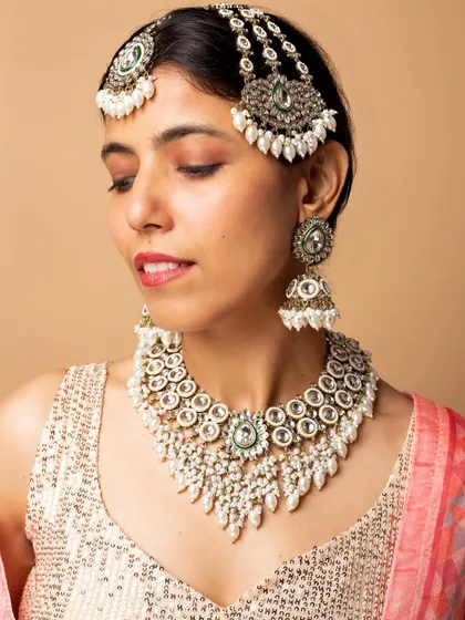 This image focuses on a different bridal set with kundan and green stones, demonstrating my ability to model a variety of traditional jewellery styles.