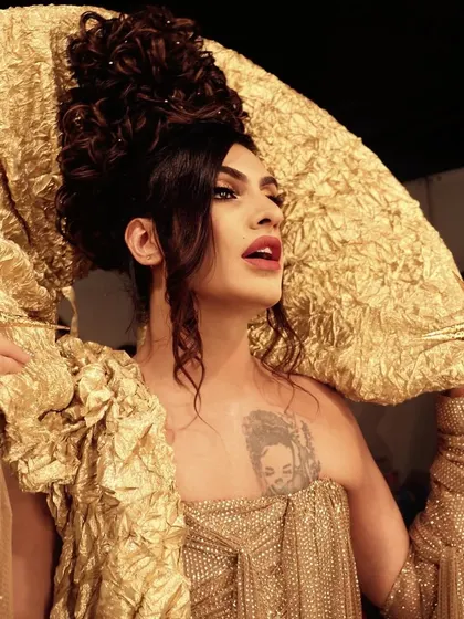 A backstage moment with Sushant Divgikr at Lakme Fashion Week. This look for the Itrh collection featured a bold red lip and dramatic, sculptural hair.
