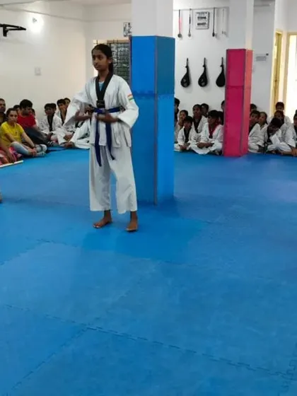 Three students demonstrate their form together.