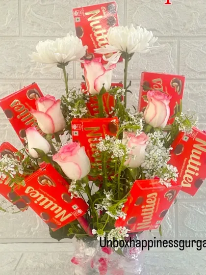 A beautiful arrangement of fresh flowers and chocolates, perfect for someone who loves both.