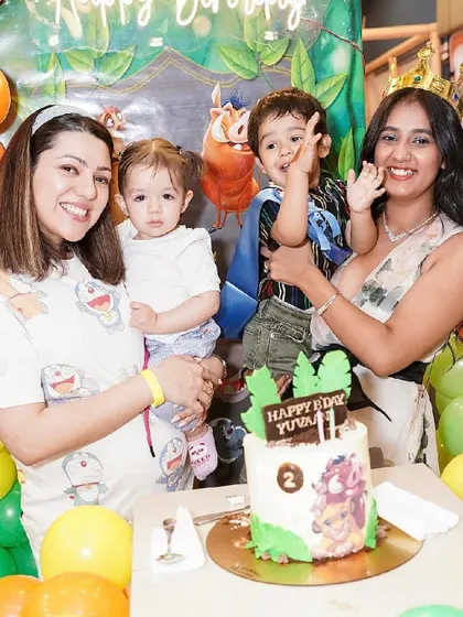 Guests and family gather around the Lion King cake to celebrate the birthday boy.