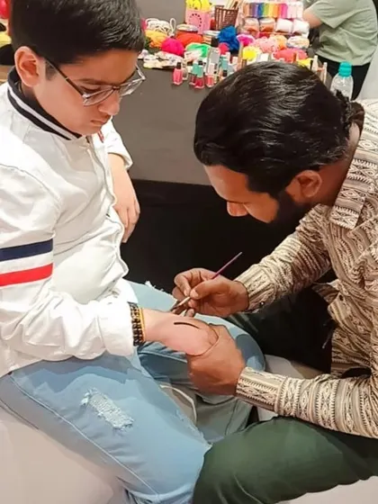 Another shot of our tattoo artist in action, providing a fun and engaging activity for the kids at the Barbie-themed party.