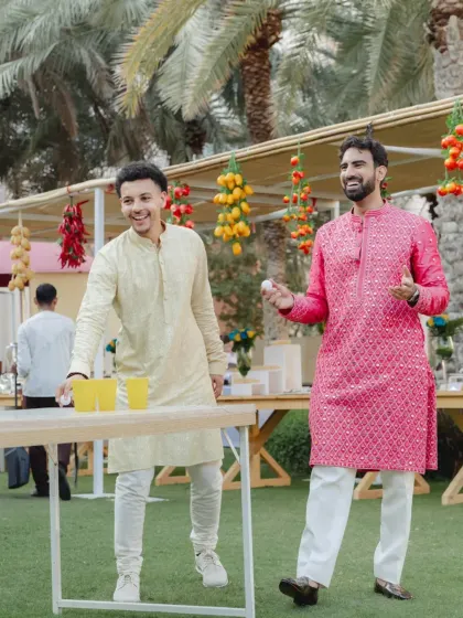 Guests enjoying a game of cup pong at an outdoor event in Oman. Interactive games are a fantastic way to get everyone involved and create a relaxed, fun atmosphere.