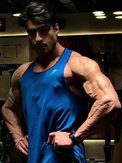 A confident pose, showing the physique that is built on sacrifice and dedication.