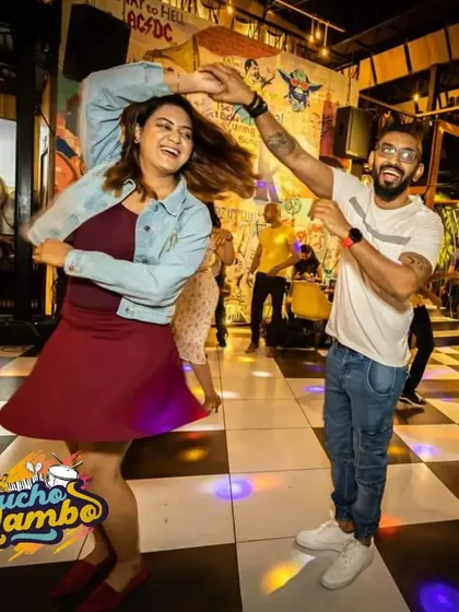 The energy at our Mucho Mambo nights is contagious. Here, two dancers are captured mid-spin, perfectly embodying the fun and freedom of social dancing.