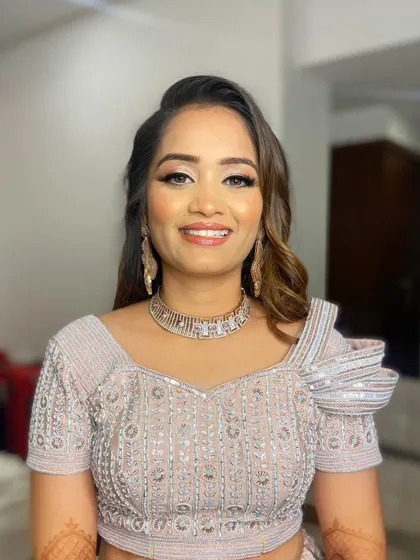 Pooja looks ready to hit the dance floor. Her makeup is bold and glamorous, perfect for a night of celebration.
