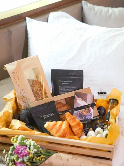 Our luxurious breakfast-in-bed hamper, designed to make any morning special. This beautiful wooden crate is filled with fresh croissants, our wheat-free granola, artisanal coffee, fresh juice, and other gourmet treats.