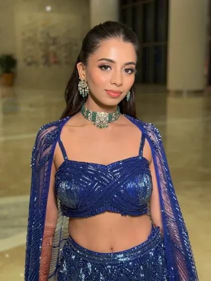 The sister of the bride deserves to shine too. Here, I paired a sharp, clean makeup look with a bold blue lehenga, focusing on a flawless base and soft smokey eyes to create a sophisticated and modern sangeet look.