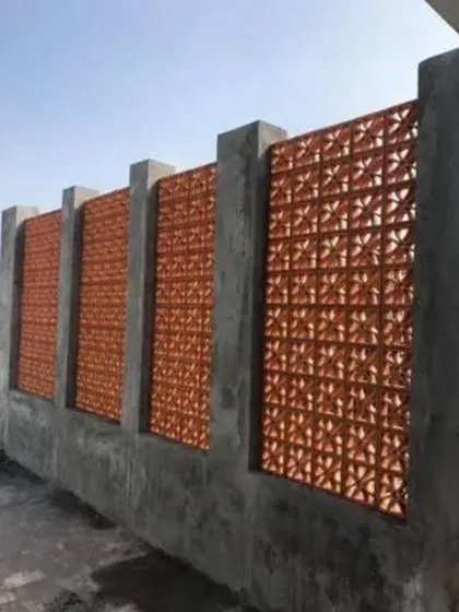 Jali blocks can also be used to construct a unique boundary wall or fence. Here, we set terracotta jali panels between concrete pillars for a decorative and semi-private perimeter.