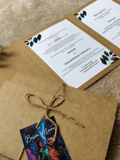 A close-up view of the kraft paper invitation, showing the texture of the paper and the simplicity of the twine bow. This style is perfect for outdoor, bohemian, or eco-conscious weddings.