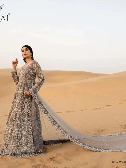 A full view of the magnificent peach with coral peach Indo-Western Gown, reflecting vibes of royalty.
