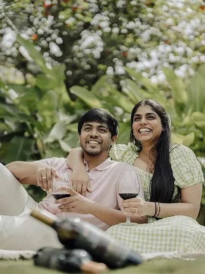 This image captures the fun and relaxed atmosphere of a pre-wedding picnic. The couple is all smiles, enjoying a casual day together before their big day.