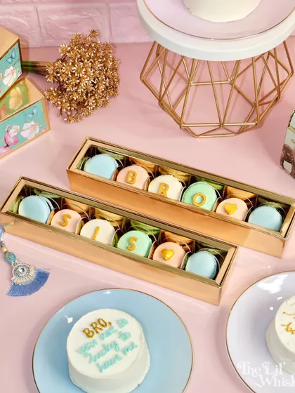 Our complete Rakhi collection on display. You can see our "Bro" and "Sis" macaron boxes alongside our custom bento cakes, offering a variety of sweet ways to celebrate your sibling.