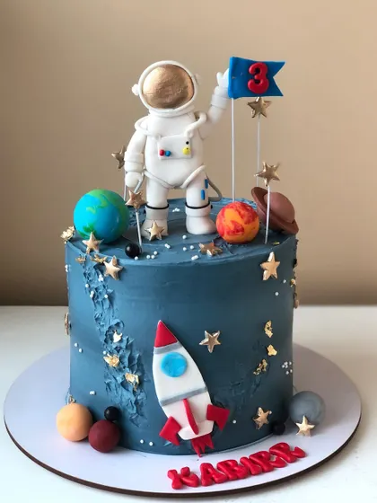An out-of-this-world astronaut cake, with a handcrafted astronaut, planets, and a rocket ship against a galaxy-blue background.