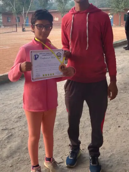 One of our youngest champions, Krisha, after winning the U-6 category. We provide a strong foundation for players starting their tennis journey.