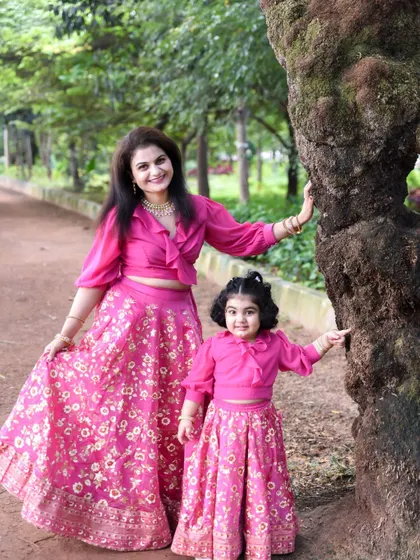 A beautiful portrait of a mother and daughter in a lush green park. Our outdoor sessions are perfect for capturing natural, relaxed family photos.