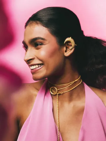 A joyful, smiling portrait from the Batoki.art campaign. This image captures a different mood, showing how the jewelry can be part of an expressive, happy moment, making the brand feel relatable and warm.