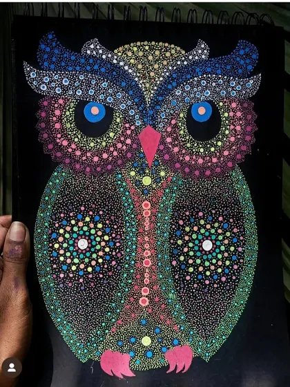A colorful owl created with dot art, featuring bright blue eyes.