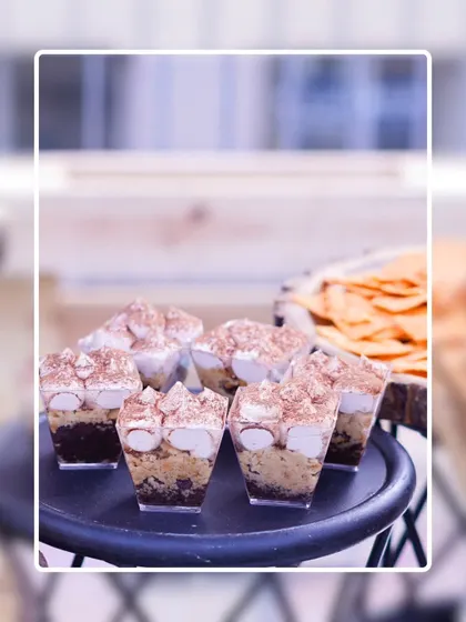 Individual Tiramisu dessert cups, layered with coffee-soaked biscuits, mascarpone cream, and a dusting of cocoa powder. A classic Italian dessert presented in a modern, convenient format.