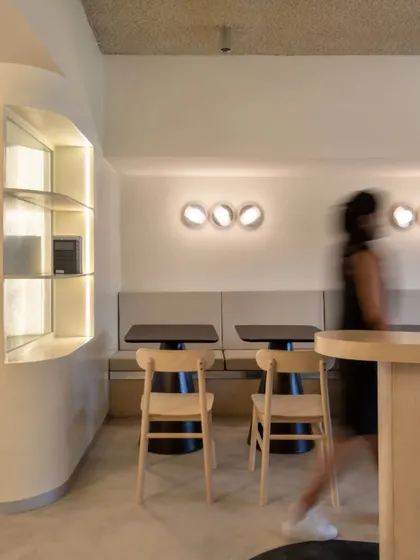 Indirect lighting is used throughout the space to create a calm, soothing atmosphere. Here, wall-mounted lights provide a soft glow over the booth seating.