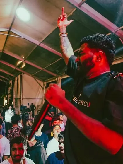 On the mic, connecting with the audience in a packed tent. I can bring the energy to any setting.