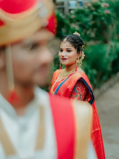 An artistic shot focusing on the bride's loving gaze towards her groom. This over the shoulder perspective creates a deeply personal and poetic frame.