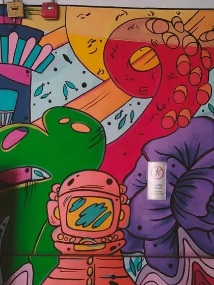 A close-up of one of my metro murals, now partially covered by a PhonePe QR code sticker. The life of a public artist!