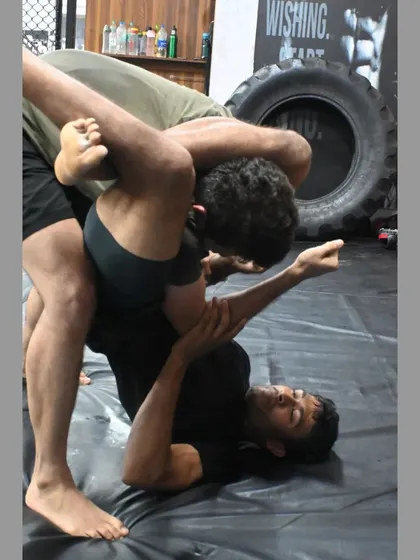 A student working to escape a triangle choke. Learning both offense and defense is crucial for a well-rounded grappling game.