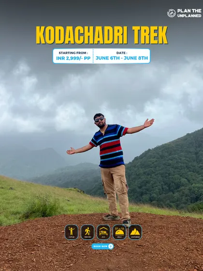 A trekker taking in the vast, misty landscape of the Western Ghats from a viewpoint on the Kodachadri trail.