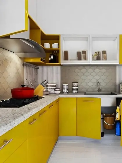 A vibrant yellow modular kitchen that brings energy and cheerfulness to the home. The design includes frosted glass cabinets and smart corner solutions to make the most of the space.