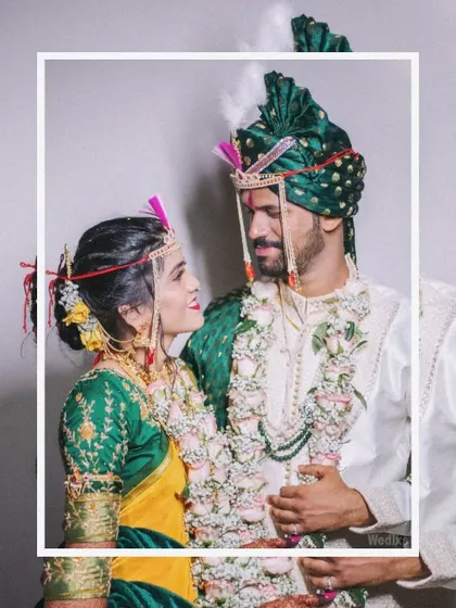 A framed portrait of a couple sharing a look during their Maharashtrian wedding, highlighting their connection and traditional wedding wear.
