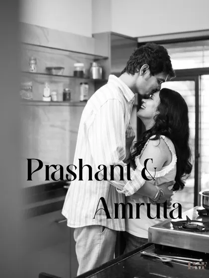 A black and white portrait from an in-home shoot. This image captures a quiet, intimate moment in the couple's own kitchen, showing that love is found in everyday life.