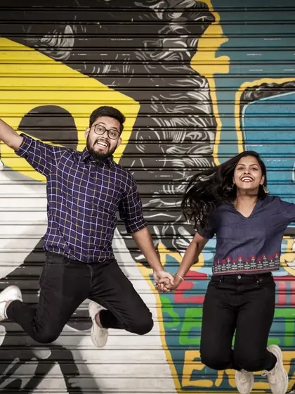 For couples who want a fun and modern vibe, I find unique spots like this graffiti wall in Delhi. This jumping shot shows a playful and energetic style of pre-wedding photography.