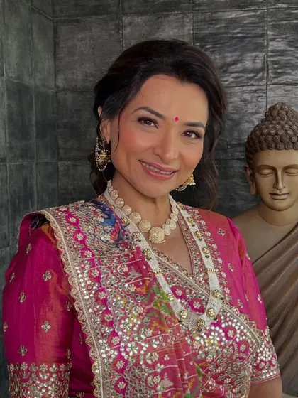 A close-up of another stunning look for the mother of the bride. The makeup is soft and radiant, with a focus on enhancing her beautiful smile.