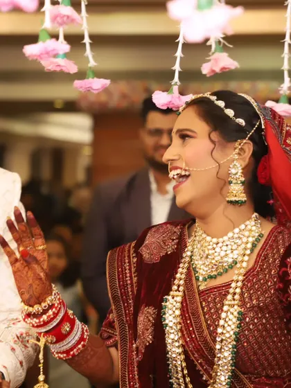 A close-up of the bride's joyful expression, her intricate jewelry and flawless makeup on full display.