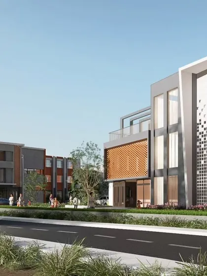 An alternate street view of the KPS School campus, highlighting the different building blocks and their relationship to one another. The composition uses a mix of solid volumes, glass facades, and textured panels to create a dynamic and contemporary look for this institutional building.